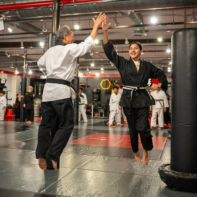 Progress is built one high five at a time — respect, effort, and teamwork on the mats!
